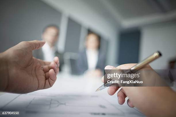close-up of hands gesturing during business meeting in office - delegating stock pictures, royalty-free photos & images