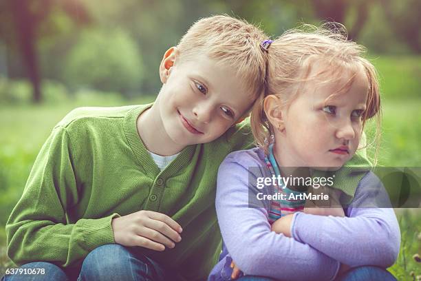 little girl and boy outdoors - apologize stockfoto's en -beelden