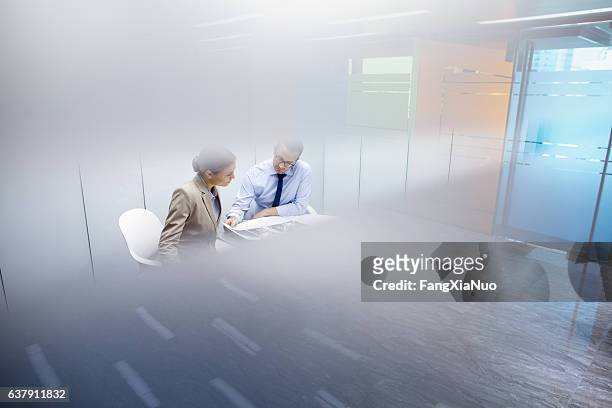 business colleagues meeting together in room - confidentiality stockfoto's en -beelden