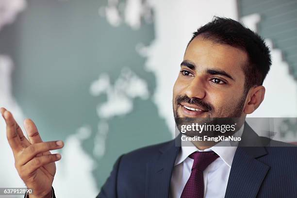 businessman talking in room with map on wall - international day one stock pictures, royalty-free photos & images