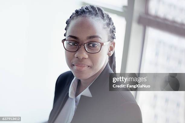 portrait of young woman in office - braided buns stock pictures, royalty-free photos & images
