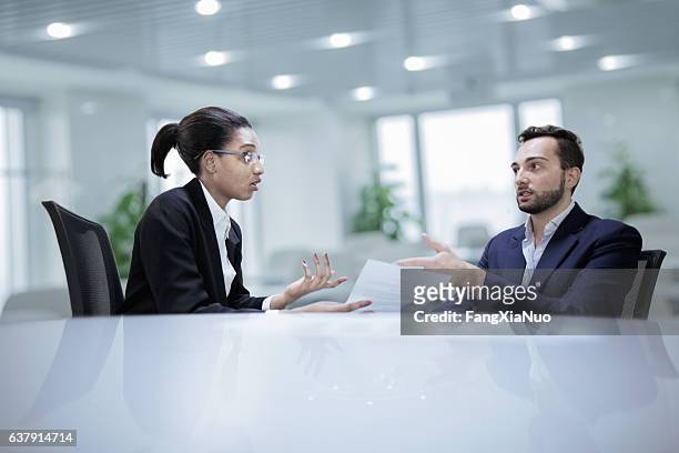 colleagues working together during discussion in office - clashes stock pictures, royalty-free photos & images