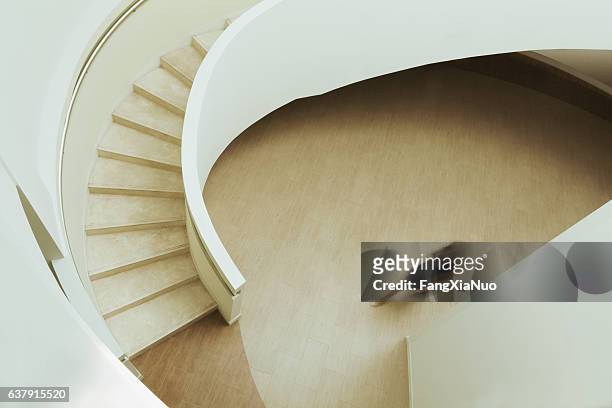 view of blurred person walking towards staircase in building - building story stock pictures, royalty-free photos & images