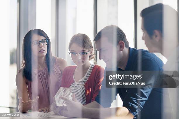 group of designers planning together in studio - trademark stock pictures, royalty-free photos & images