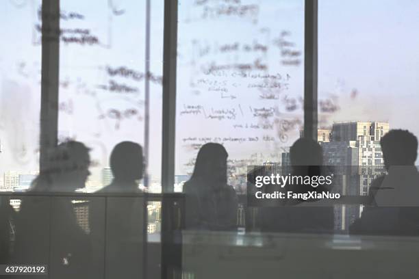 silhouette shadows of business team meeting in office - bestuur stockfoto's en -beelden