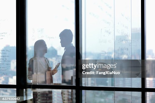 Silhouette shadows of business people talking in office Silhouette shadows of business people talking in office