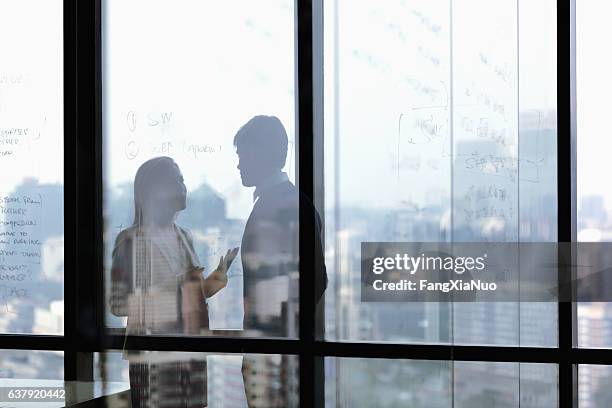 silhouette shadows of business people talking in office - job shadow stock pictures, royalty-free photos & images