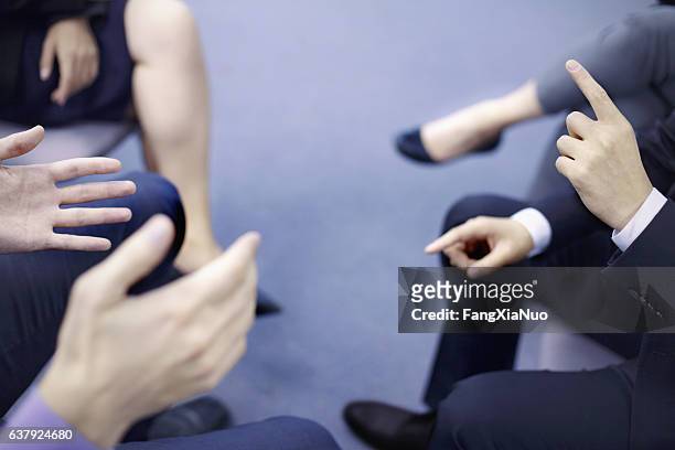 hands of business people interacting in office meeting - vechten stockfoto's en -beelden