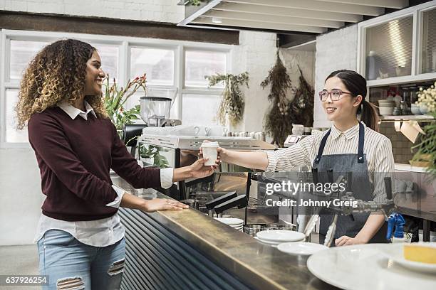 young woman serving female customer in cafe - australian cup day stock pictures, royalty-free photos & images