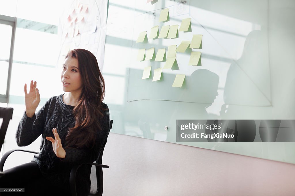 Woman discussing ideas and strategy in studio office