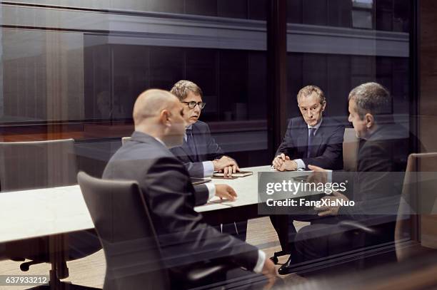 executive businessmen talking in meeting room - member of parliament nicky morgan interview stockfoto's en -beelden