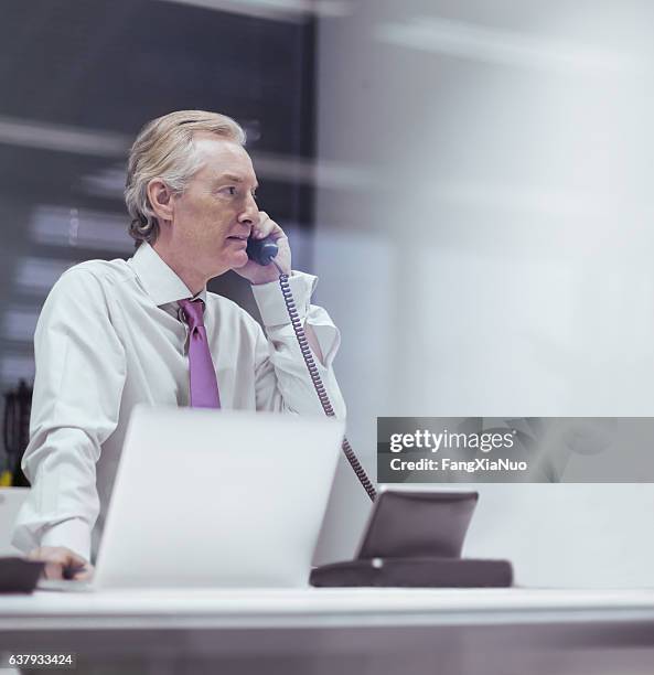 Businessman Talking On Phone In Business Office High-Res Stock Photo