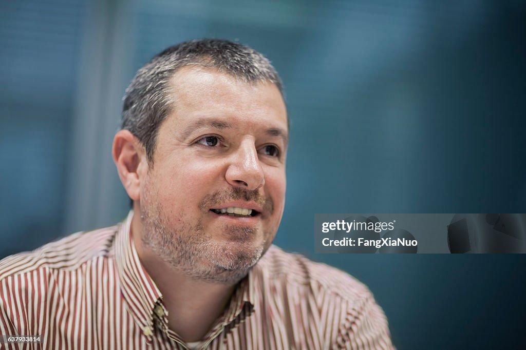 Portrait of businessman smiling in business office