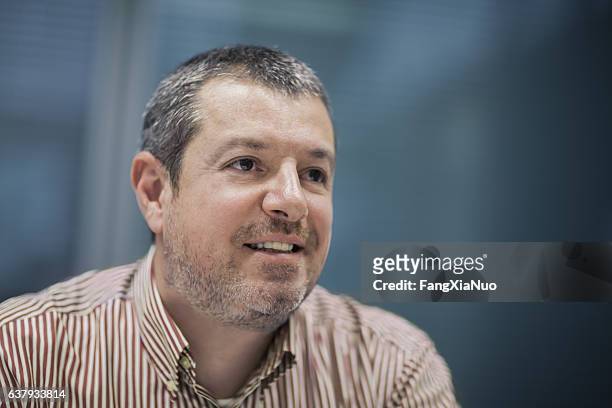 portrait of businessman smiling in business office - interview event stock pictures, royalty-free photos & images