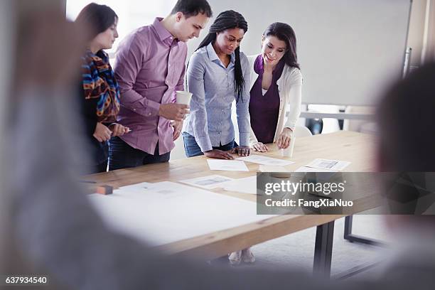 group of designers collaborating in office studio - focus group discussion stock pictures, royalty-free photos & images