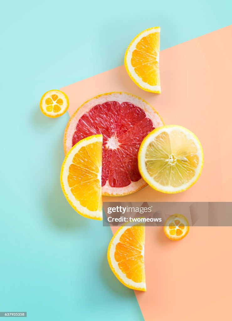 Flat lay citrus fruits on graphical background.