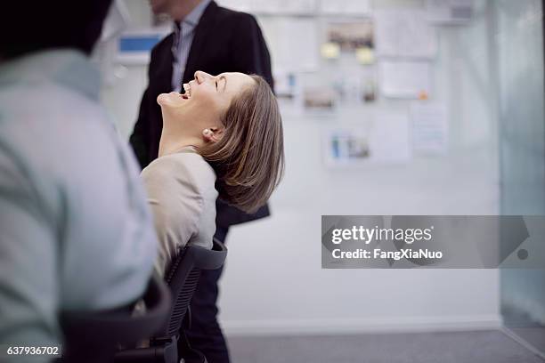 businesswoman laughing reaction in office team meeting - excitement stockfoto's en -beelden