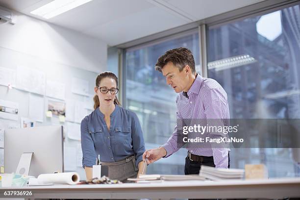 colleagues collaborating in design studio office - intellectueel eigendom stockfoto's en -beelden