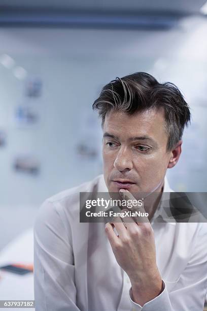 portrait of man thinking in design studio office - teacher studio portrait stock pictures, royalty-free photos & images