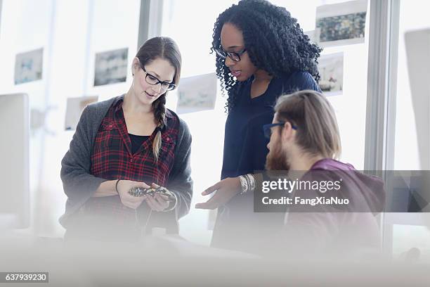 creative colleagues reviewing product samples in studio office - patent stock pictures, royalty-free photos & images