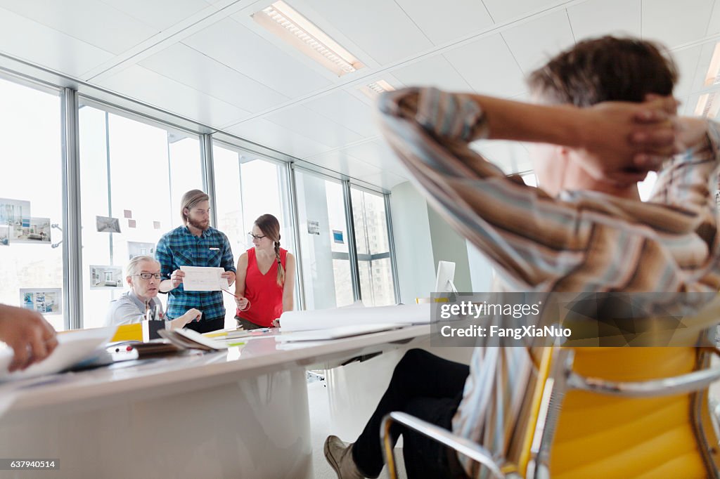 Business colleagues interacting in large conference room