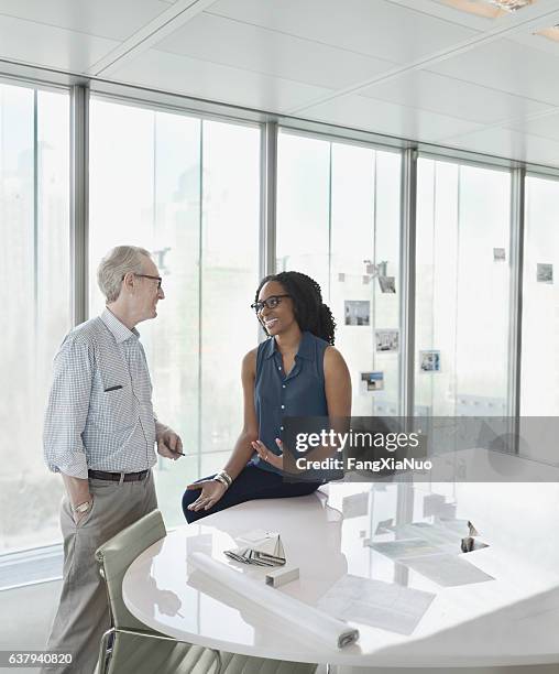 colleagues talking together in conference meeting room - agency stock pictures, royalty-free photos & images