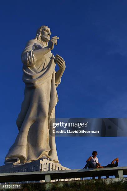 The Cristo de La Habana statue towers over visitors on a hilltop overlooking the bay in Havana, Cuba on December 22, 2015. The 20-meter high...