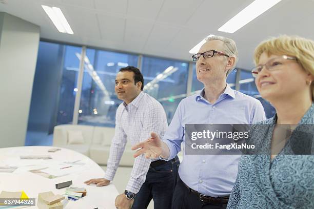 colleagues talking during presentation in studio office - arbetsförmedling bildbanksfoton och bilder