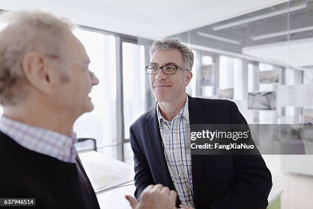 pair of mature men talking together in design agency - gallery 2 stock pictures, royalty-free photos & images