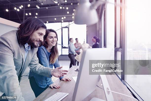 pair of fashion designers discussing ideas in design studio environment - hitech moda stock pictures, royalty-free photos & images