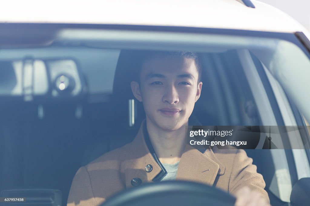 Young asian man driver in the car