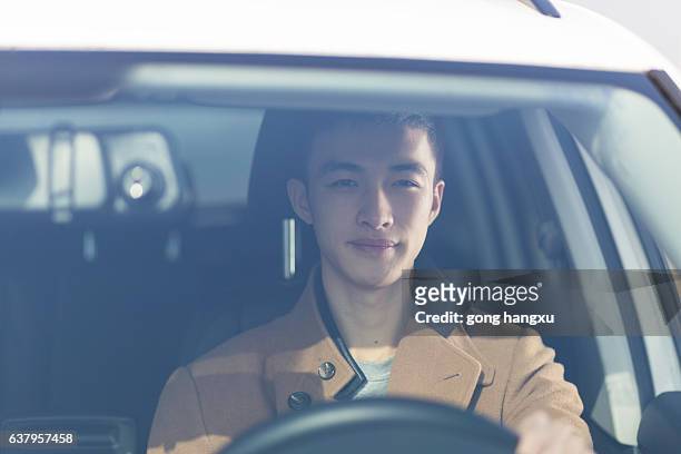young asian man driver in the car - asian man car stock pictures, royalty-free photos & images