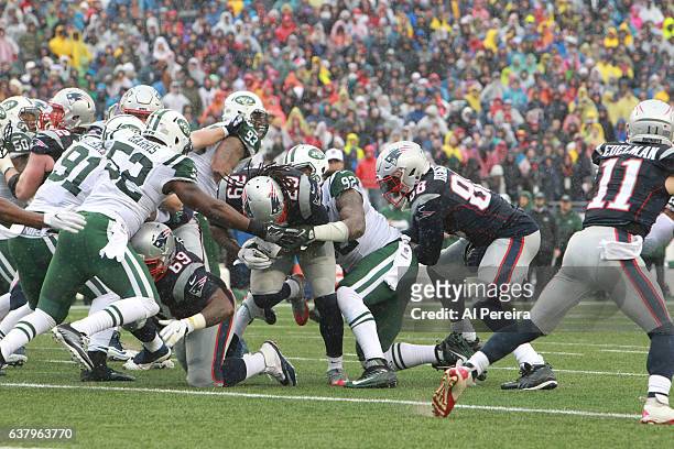 Defensive Lineman Leonard Williams and Linebacker David Harris of the New York Jets make a stop against the New England Patriots at Gillette Stadium...
