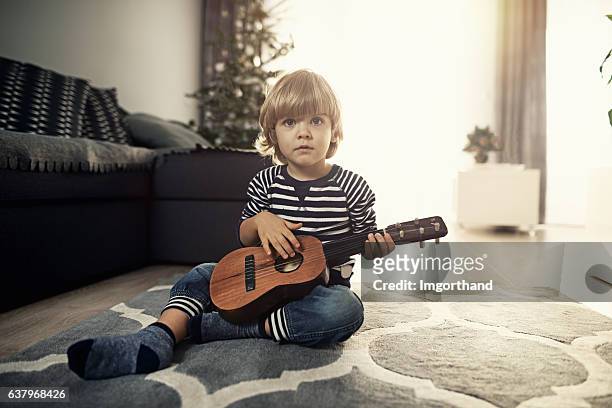 cute 2 years old little boy playing guitar - 2 3 years stock pictures, royalty-free photos & images