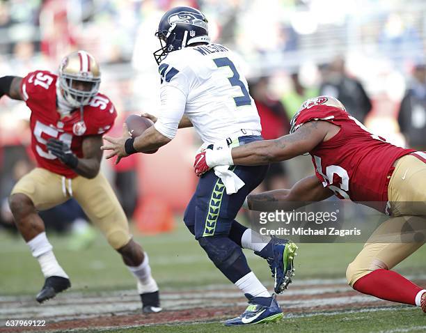 Ahmad Brooks of the San Francisco 49ers drags down Russell Wilson of the Seattle Seahawks during the game at Levi Stadium on January 1, 2017 in Santa...