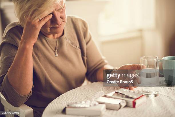 i am going to take a painkiller for my headache! - medicine dose stock pictures, royalty-free photos & images