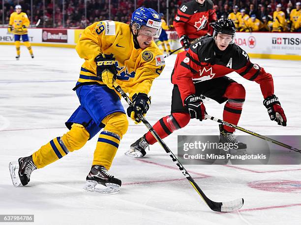 Tim Soderlund of Team Sweden skates the puck against Thomas Chabot of Team Canada during the 2017 IIHF World Junior Championship semifinal game at...