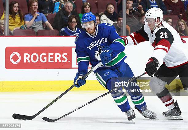 Michael Stone of the Arizona Coyotes checks Jack Skille of the Vancouver Canucks during their NHL game at Rogers Arena January 4, 2017 in Vancouver,...