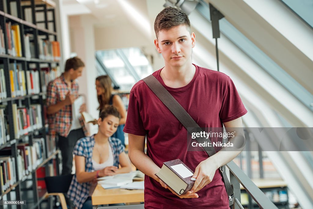 Portrait of university student holding book