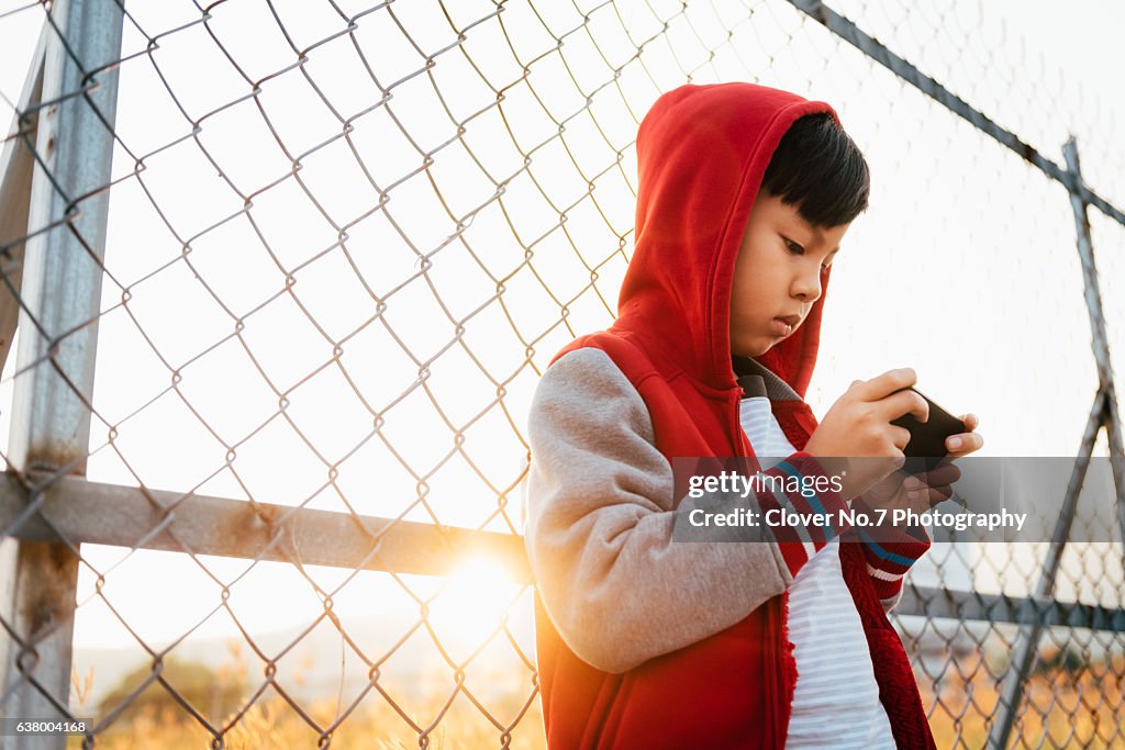 Asian boy with smartphone.