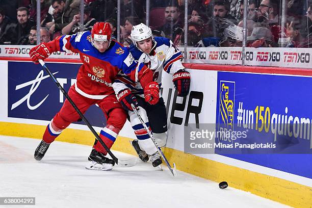 Vadim Kudako of Team Russia and Clayton Keller of Team United States battle for the puck against the boards during the 2017 IIHF World Junior...