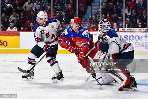 Casey Fitzgerald of Team United States and Denis Guryanov of Team Russia battle for position in front of goaltender Tyler Parsons during the 2017...