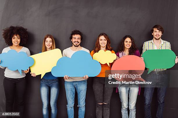 happy friends holding speech bubbles - aha moment student stock pictures, royalty-free photos & images