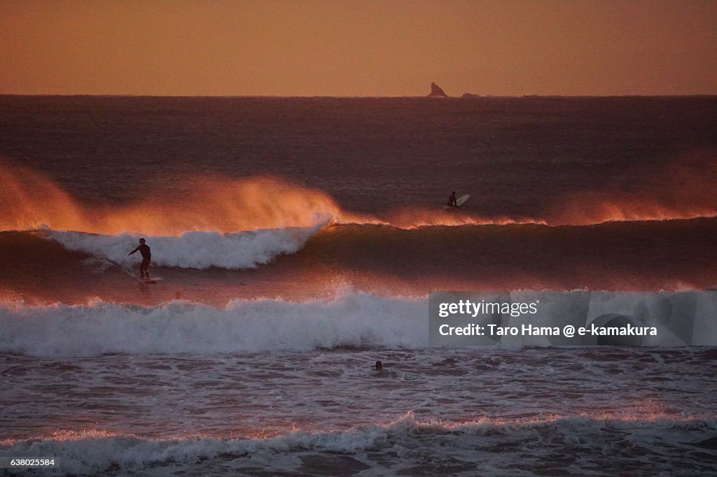 Surfing on the sunset beach