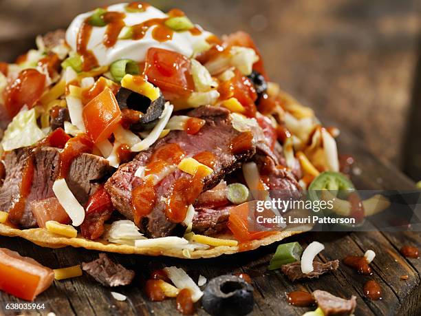 steak and cheese tostada with hot sauce - tostada stock pictures, royalty-free photos & images