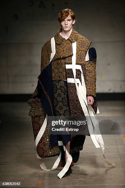 Model walks the runway at the Craig Green show during London Fashion Week Men's January 2017 collections at BFC Show Space on January 6, 2017 in...