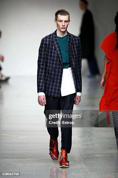 Model walks the runway at the Casely-Hayford show during London Fashion Week Men's January 2017 collections at BFC Show Space on January 7, 2017 in...