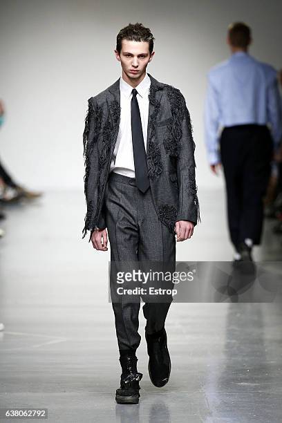 Model walks the runway at the Casely-Hayford show during London Fashion Week Men's January 2017 collections at BFC Show Space on January 7, 2017 in...