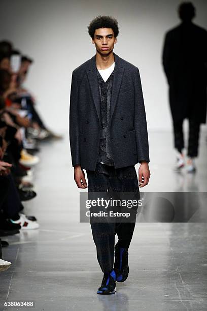 Model walks the runway at the Casely-Hayford show during London Fashion Week Men's January 2017 collections at BFC Show Space on January 7, 2017 in...