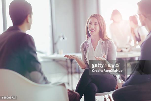 office coworkers talking during meeting together in design studio - casual clothing stock pictures, royalty-free photos & images